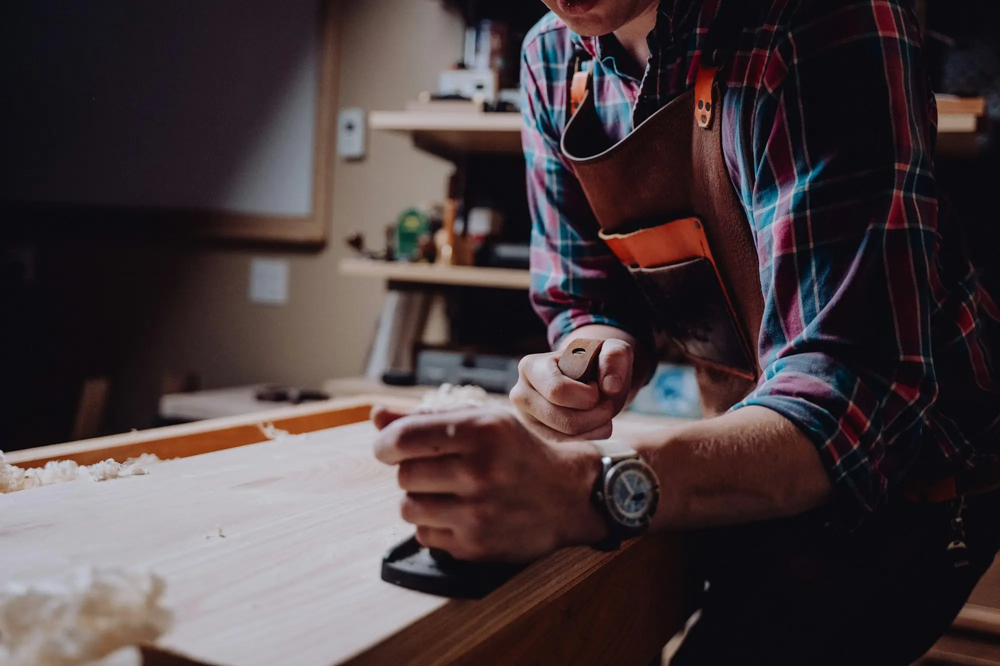 Workshop owner taking a phone call at his bench
