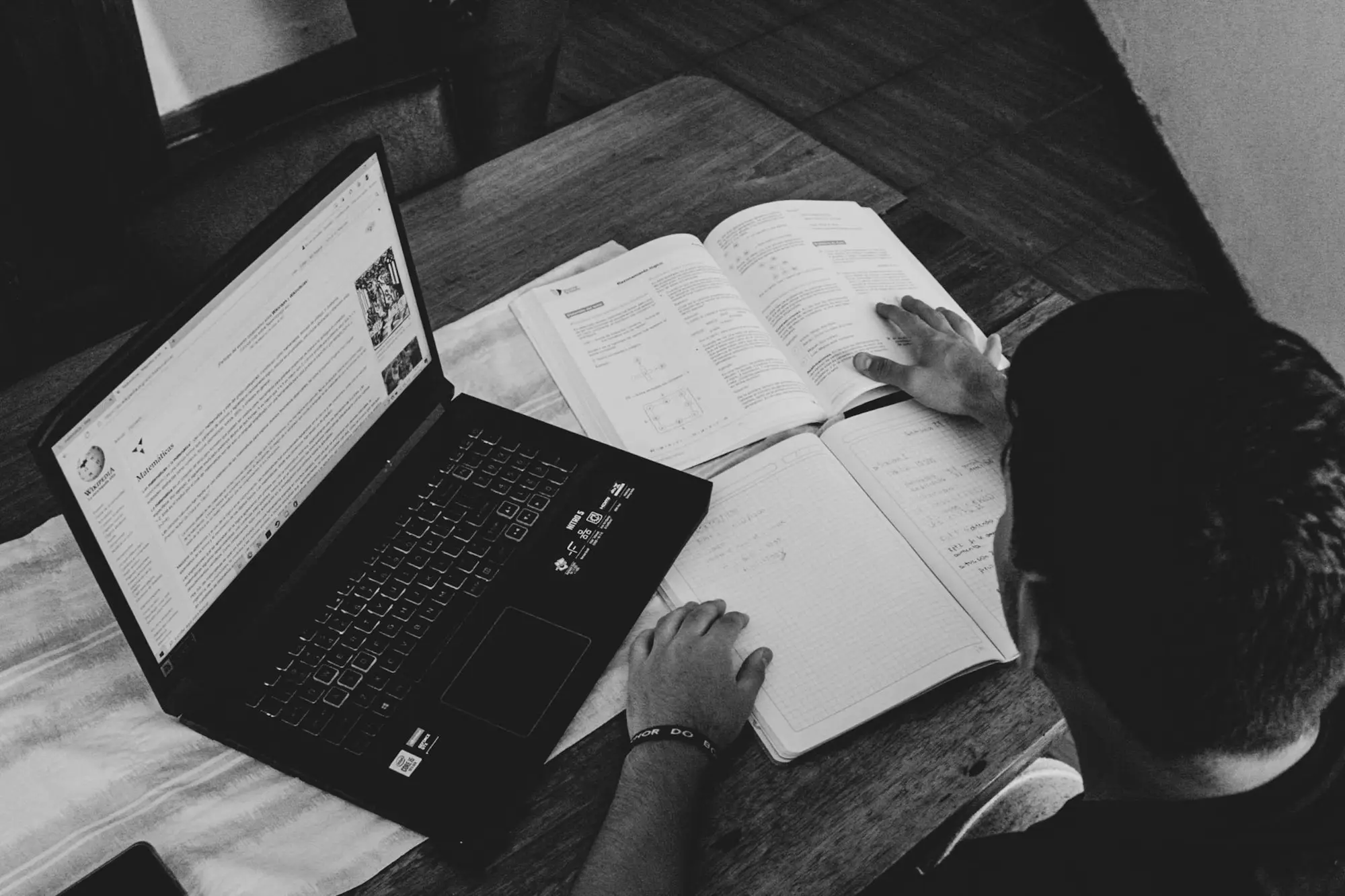 Business owner reviewing a loan statement beside a laptop