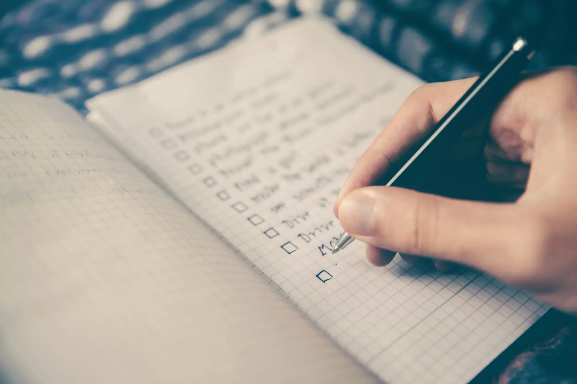 Business owner writing call notes in a notebook