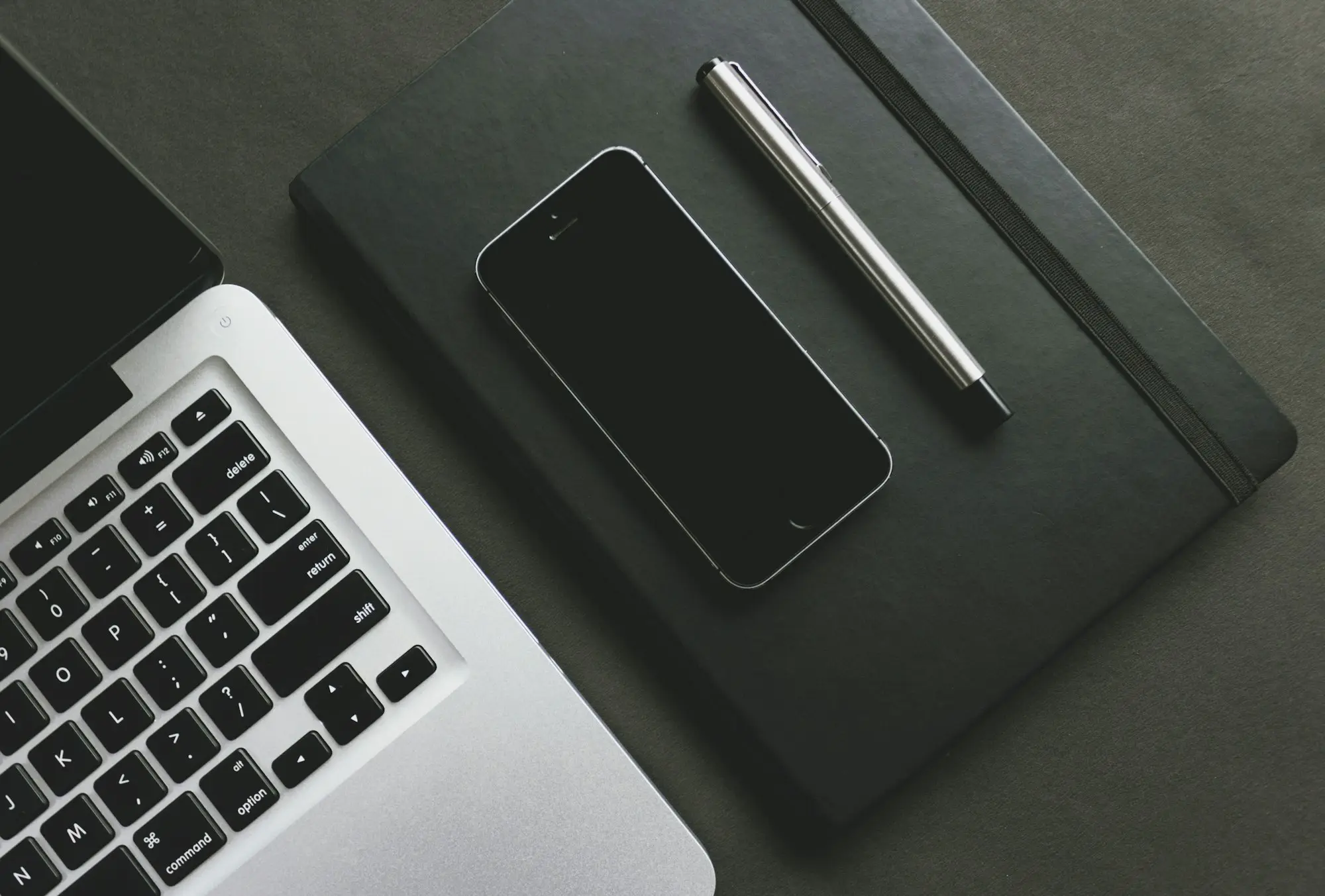 Laptop, phone and pen on a desk ready for a call