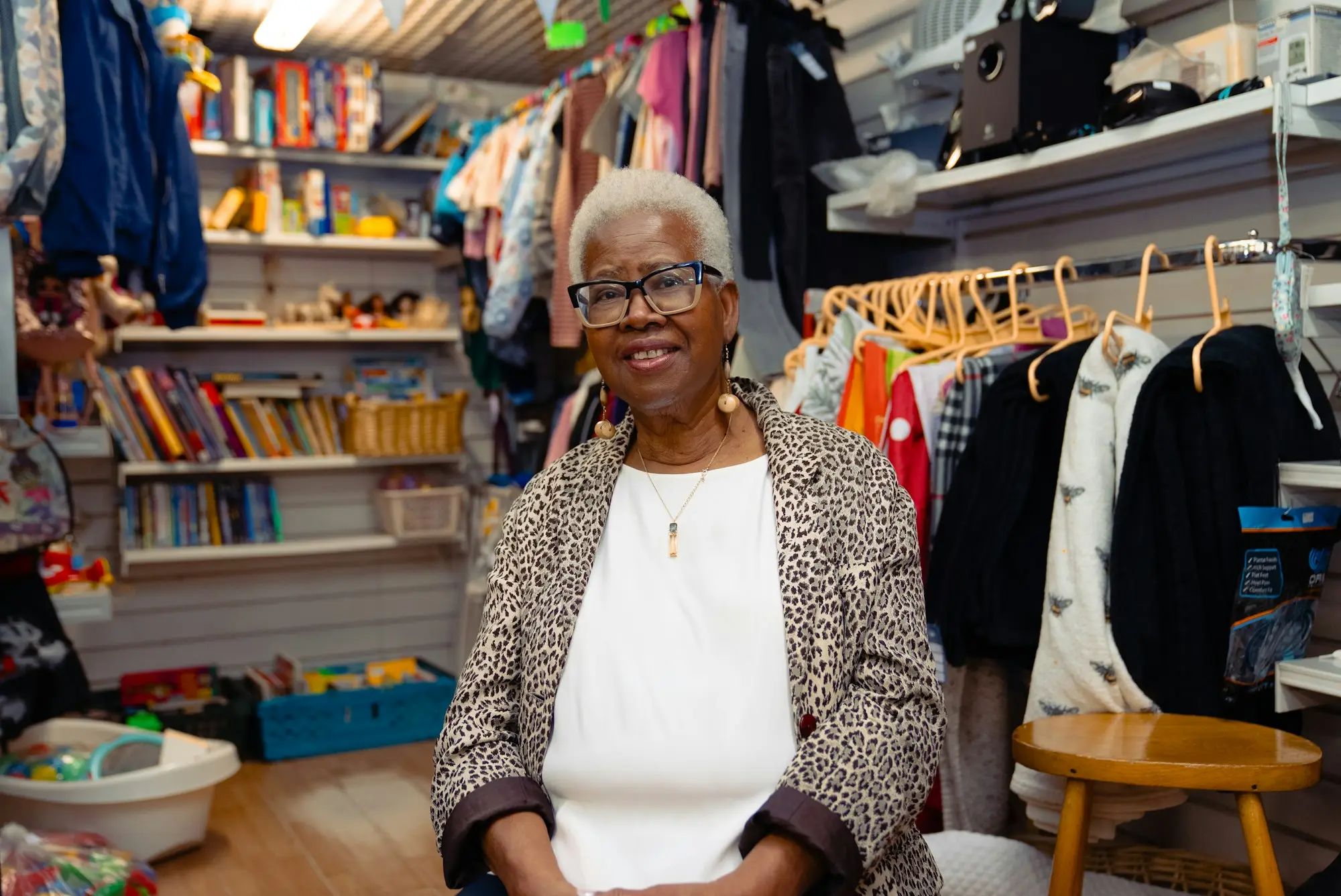 Retailer smiling in her stockroom